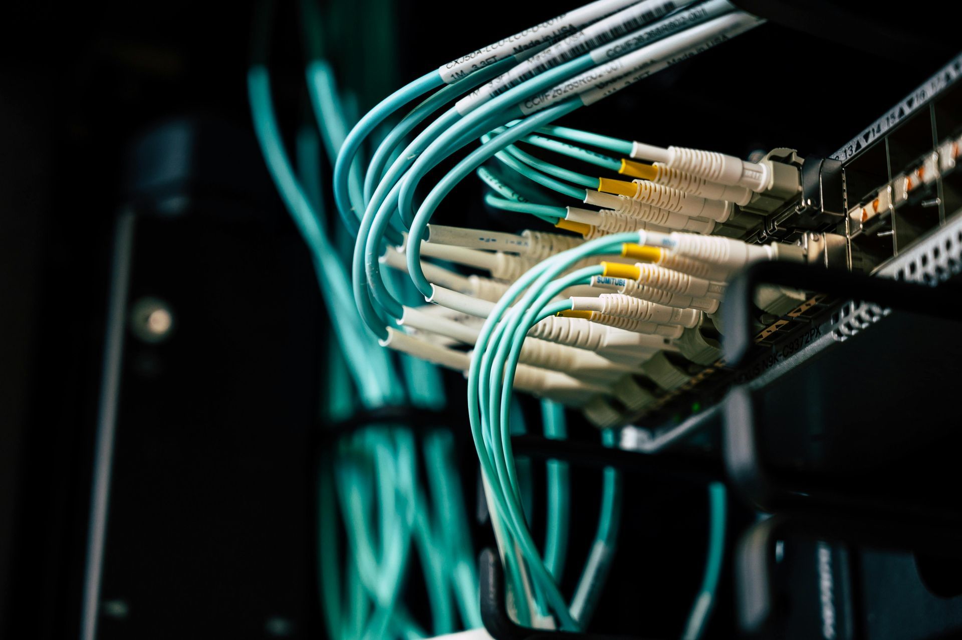 A bunch of wires are connected to a server in a data center.