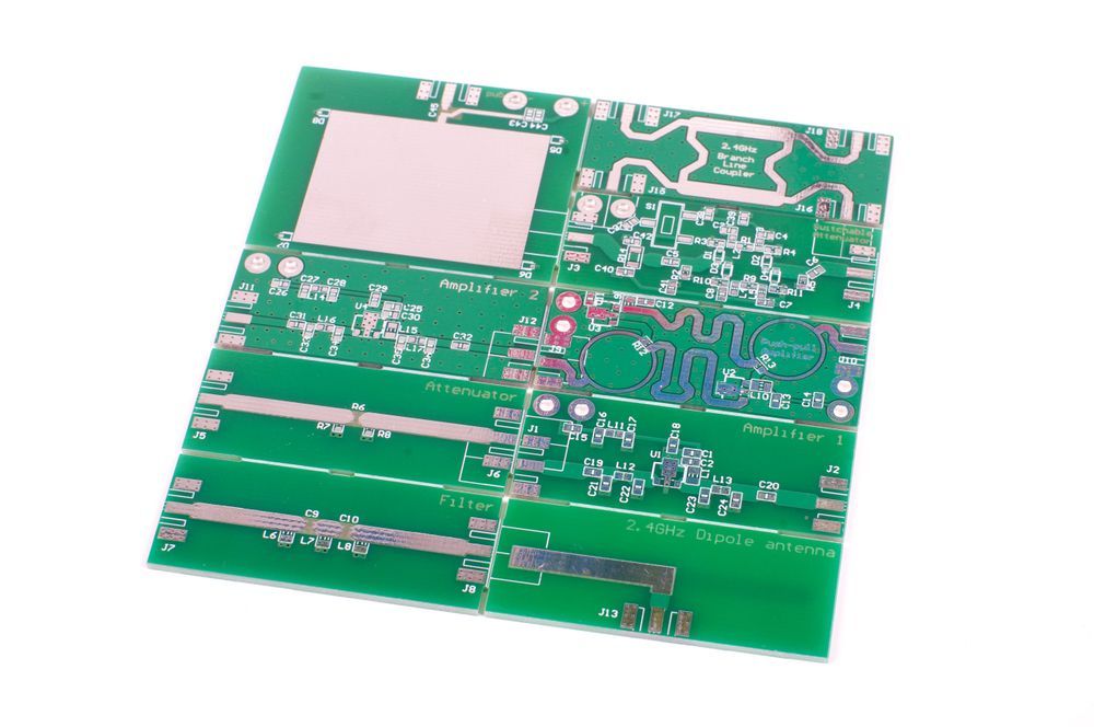 Green circuit board with various electronic components.