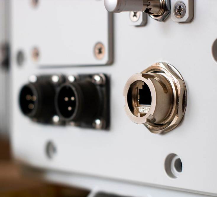 Person's hands interacting with a holographic display showing sustainability and electronics.
