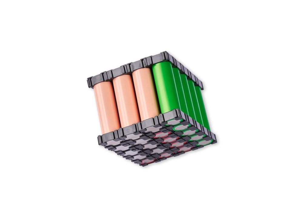 Battery pack with cylindrical cells, alternating peach and green, encased in a black grid.