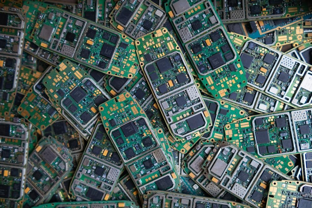 Pile of green circuit boards showcasing sustainability and electronics.