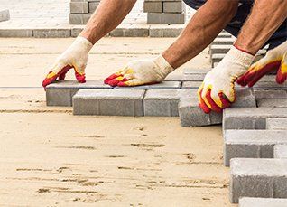 Workers Lay Paving Tiles — Tulsa, OK — Spencer Concrete & Excavation LLC
