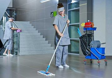 Worker with mop cleaning the floor Worker with mop cleaning the floor