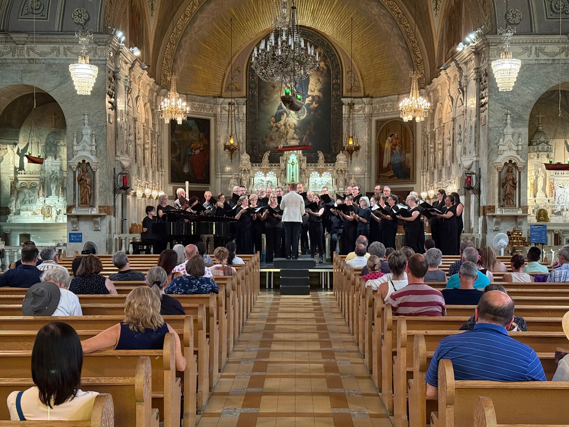 A large group of people are posing for a picture in a church.