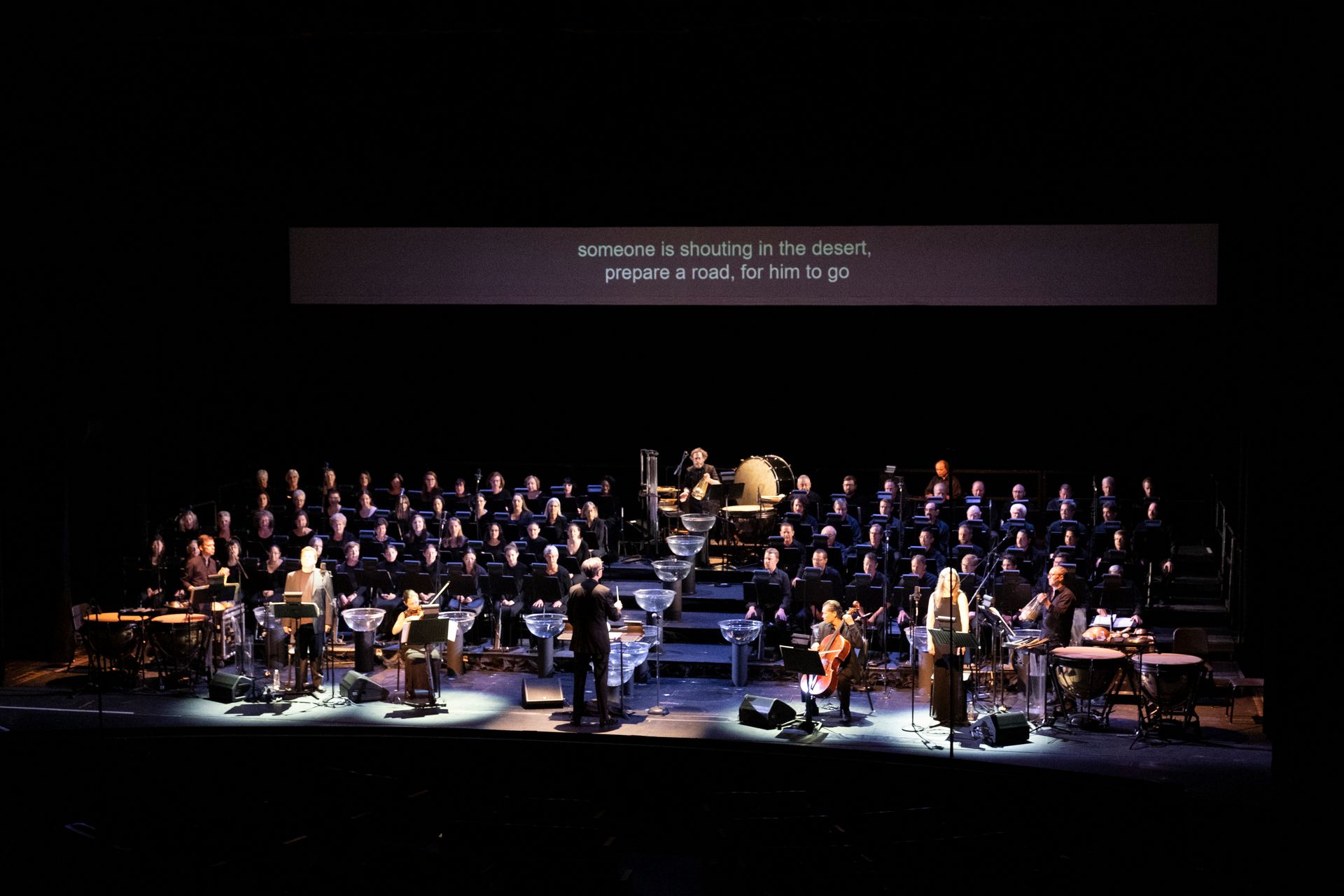 A large group of people are playing instruments on a stage.