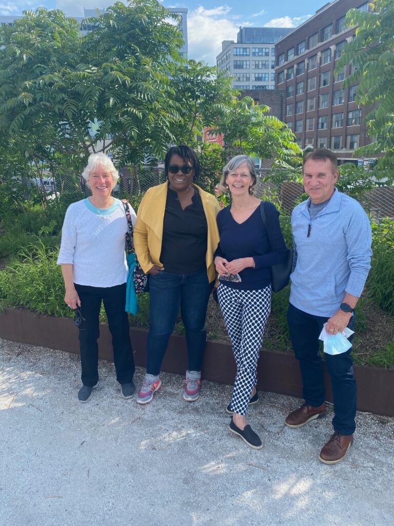 A group of people are standing next to each other in a park.