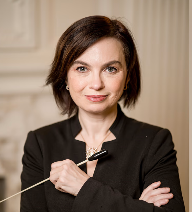 A woman wearing a black dress and a pearl necklace