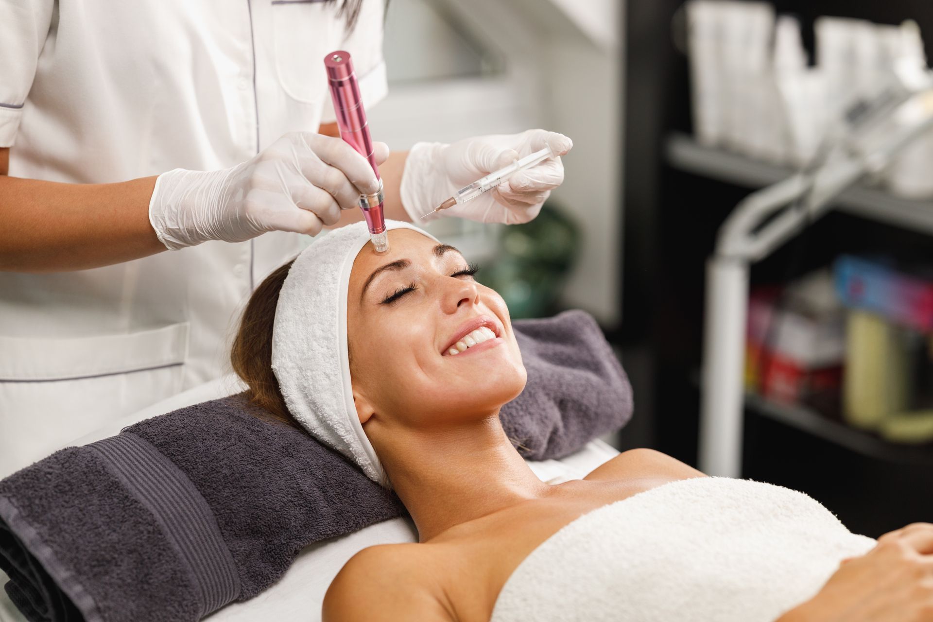 A woman is getting a facial treatment in a beauty salon.