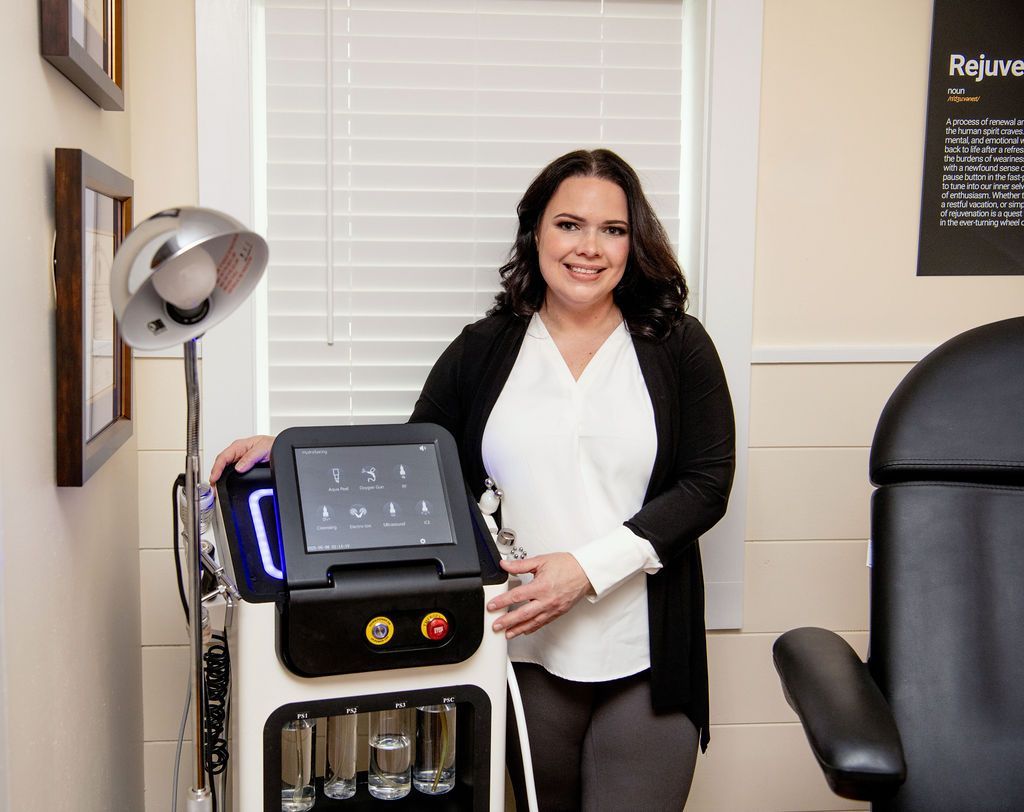 A woman is smiling and touching her face with her hands.