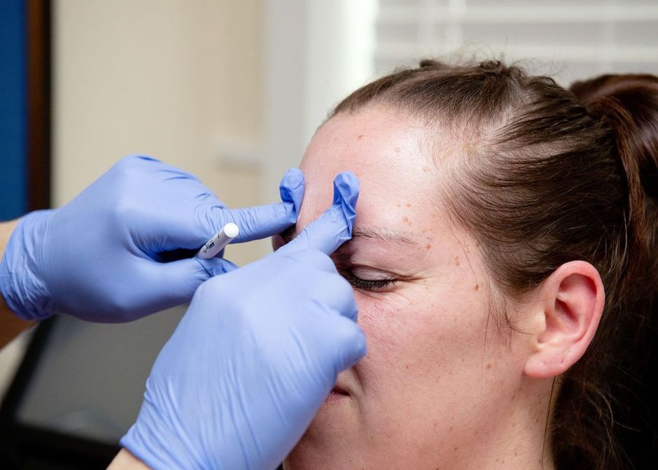 A woman is getting a facial treatment at a beauty salon.
