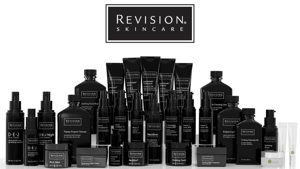 A collection of revision skincare products are lined up on a table.