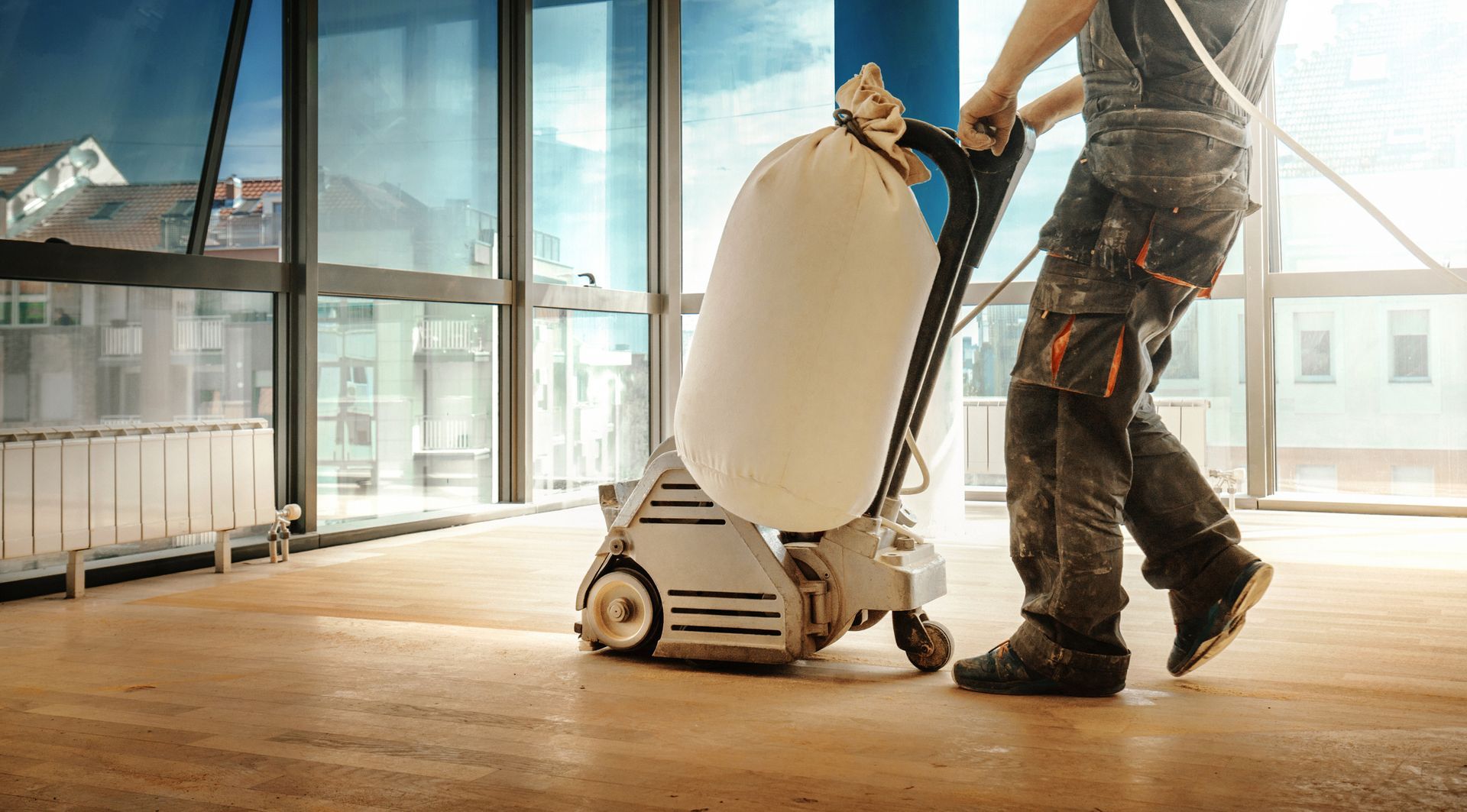 A professional doing floor sanding services in Spanaway, WA