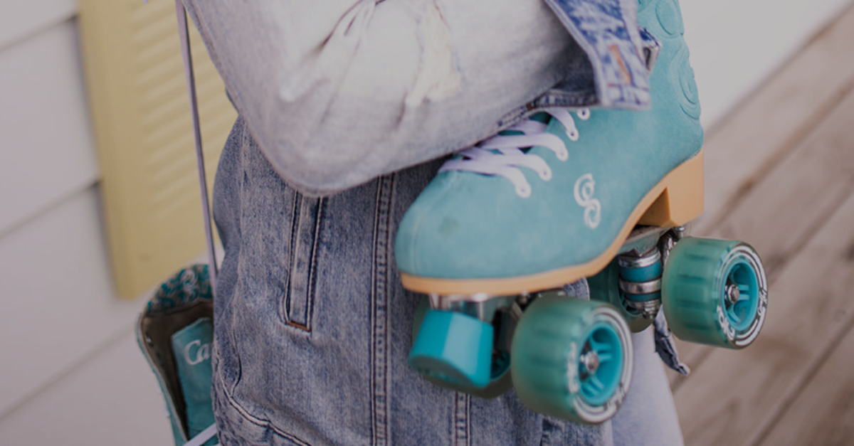 A person is wearing a pair of blue roller skates.
