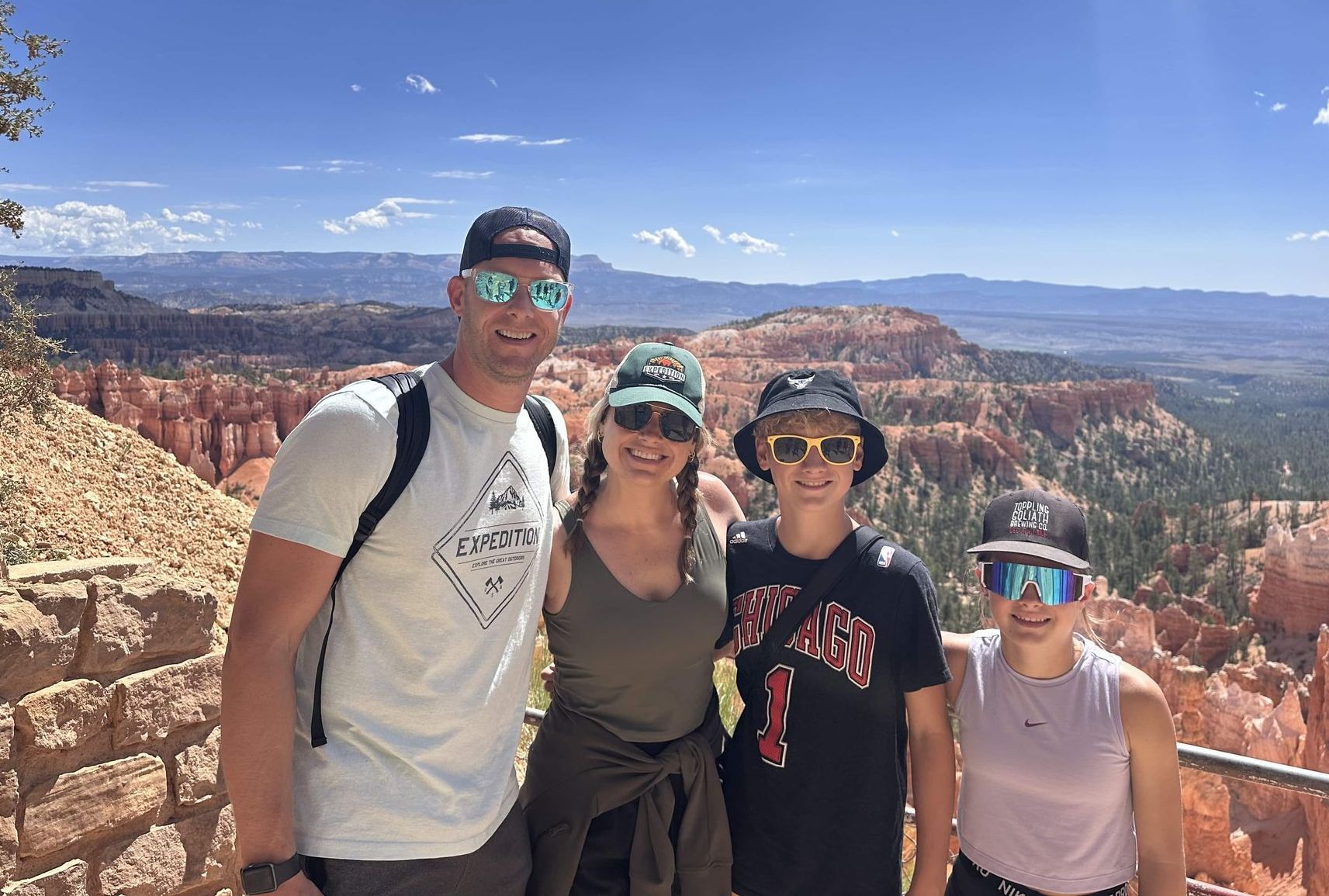 A family posing for a picture in a field of tall grass.