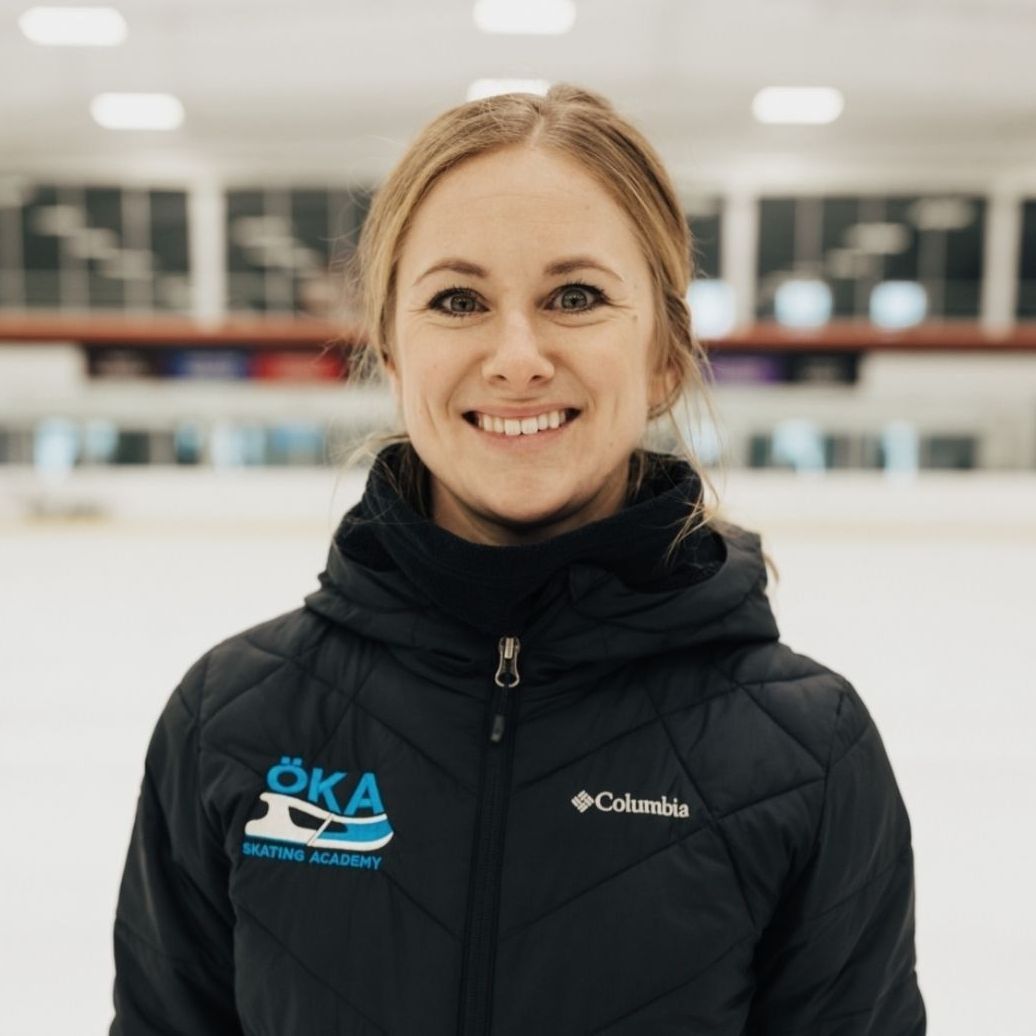 A woman wearing a black columbia jacket smiles for the camera