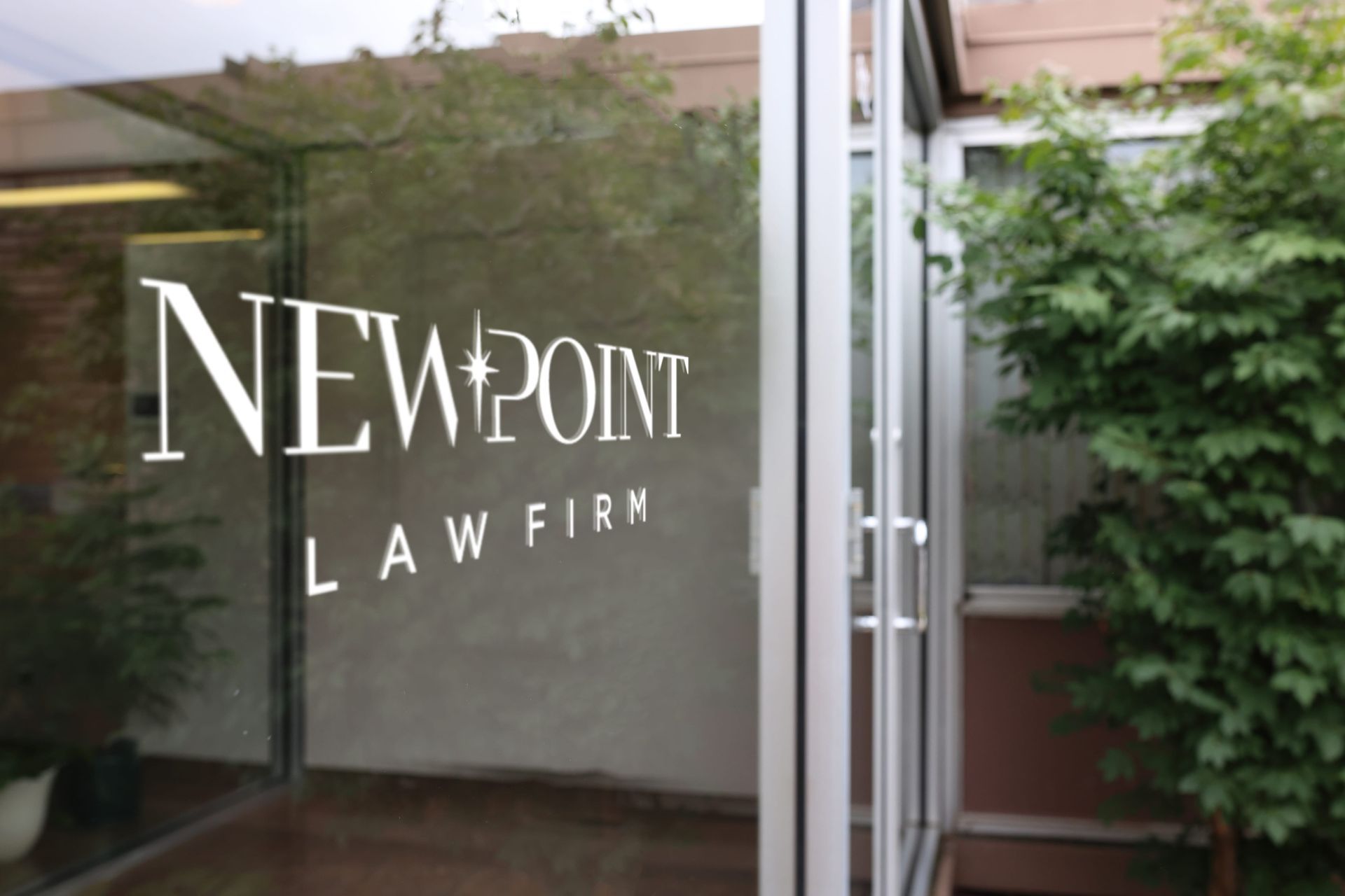 A glass door with the words newpoint law firm on it