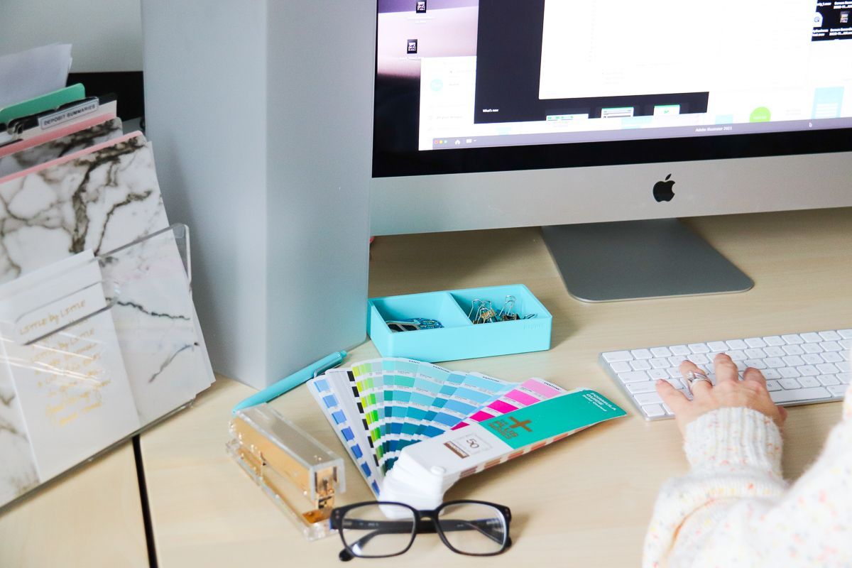Desktop look with desktop, keyboard, file folders, color palette, glasses, paperclips