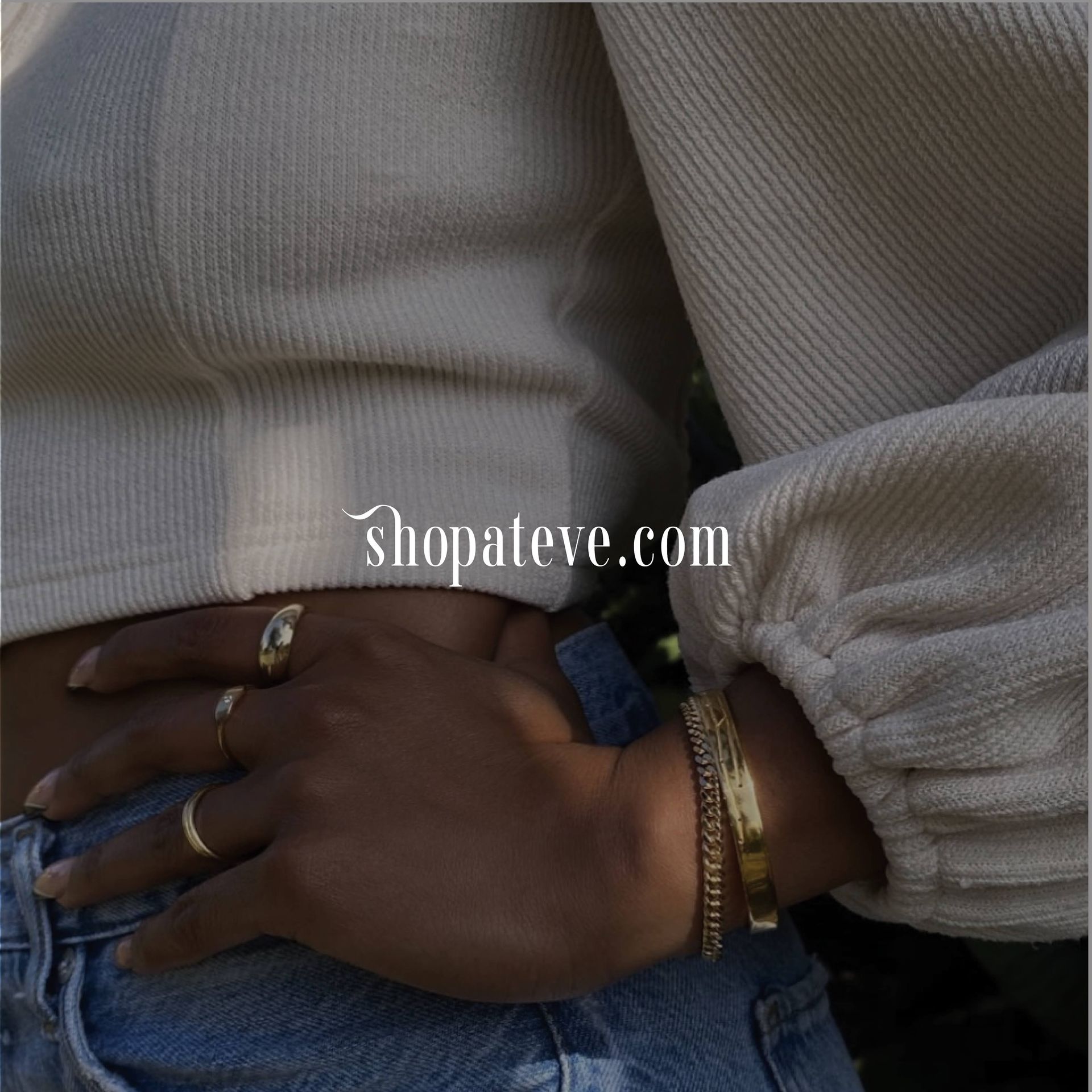 A woman wearing a bracelet and a ring on her wrist