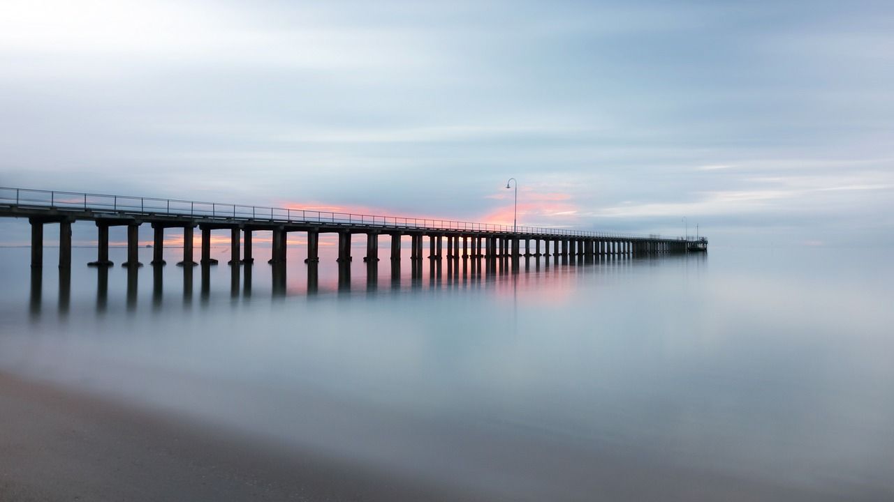 There is a pier in the middle of the ocean.