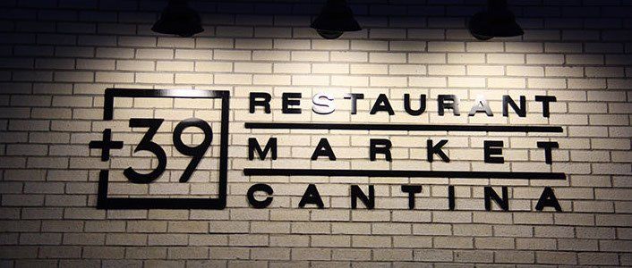 A sign on a brick wall that says restaurant 39 market cantina