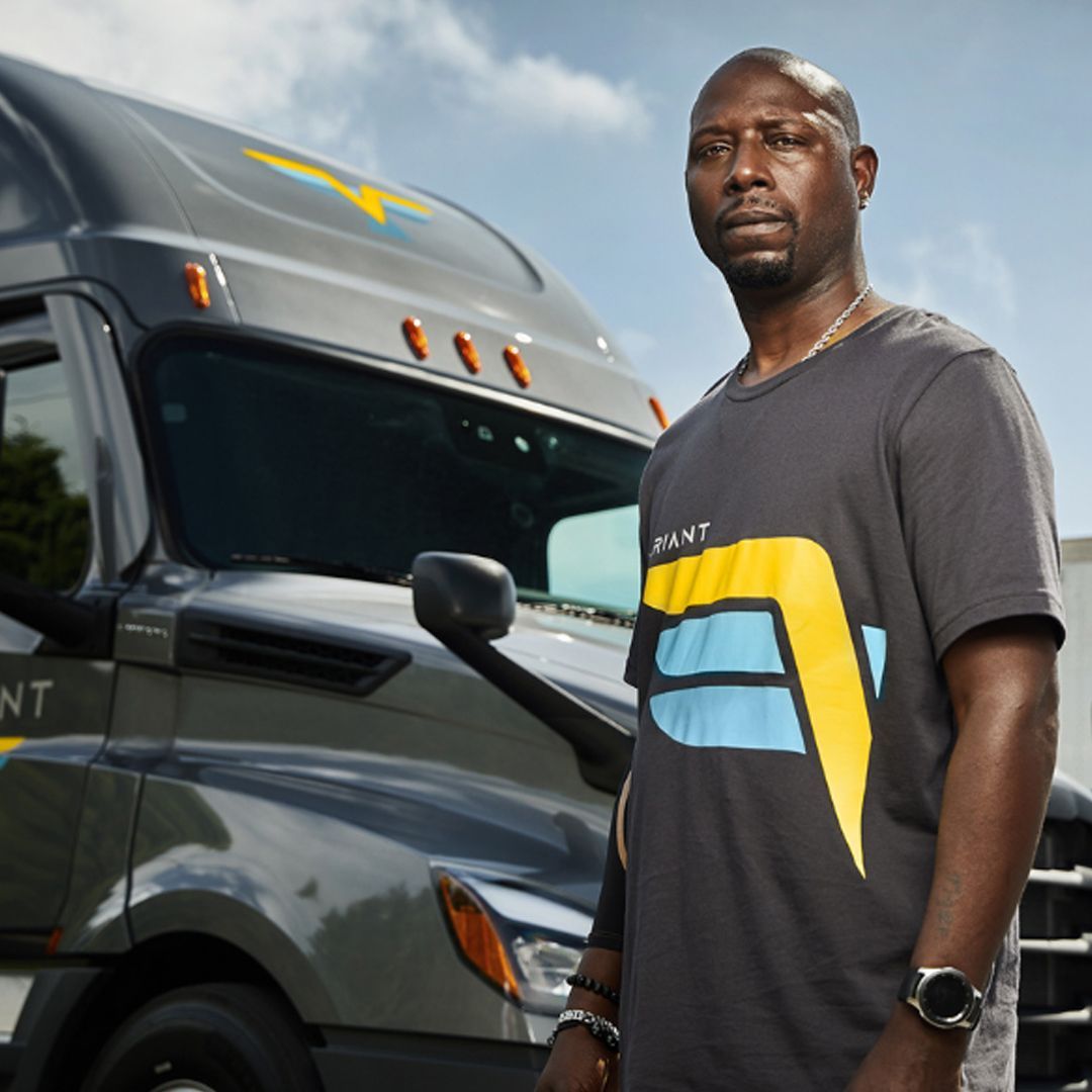 Variant Truck Driver Standing by His Tractor