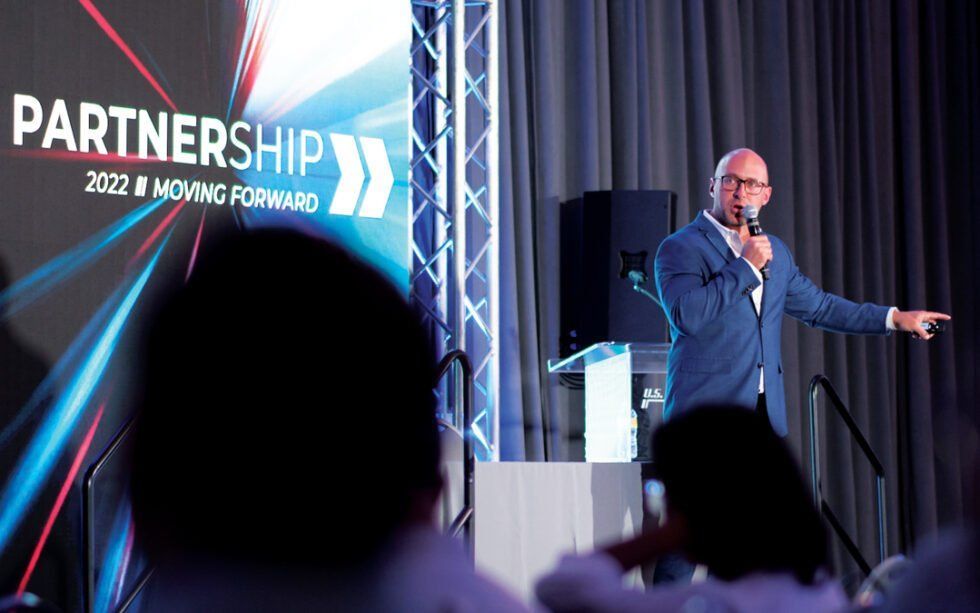 Speaker on stage at U.S. Xpress 2022 Customer Summit 