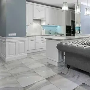 Modern white and gray kitchen with marble floors and a tufted gray sofa island
