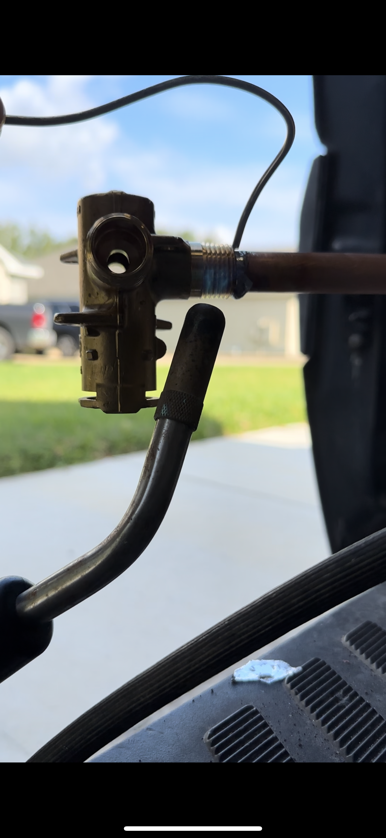 A close up of a pipe with a hose attached to it.