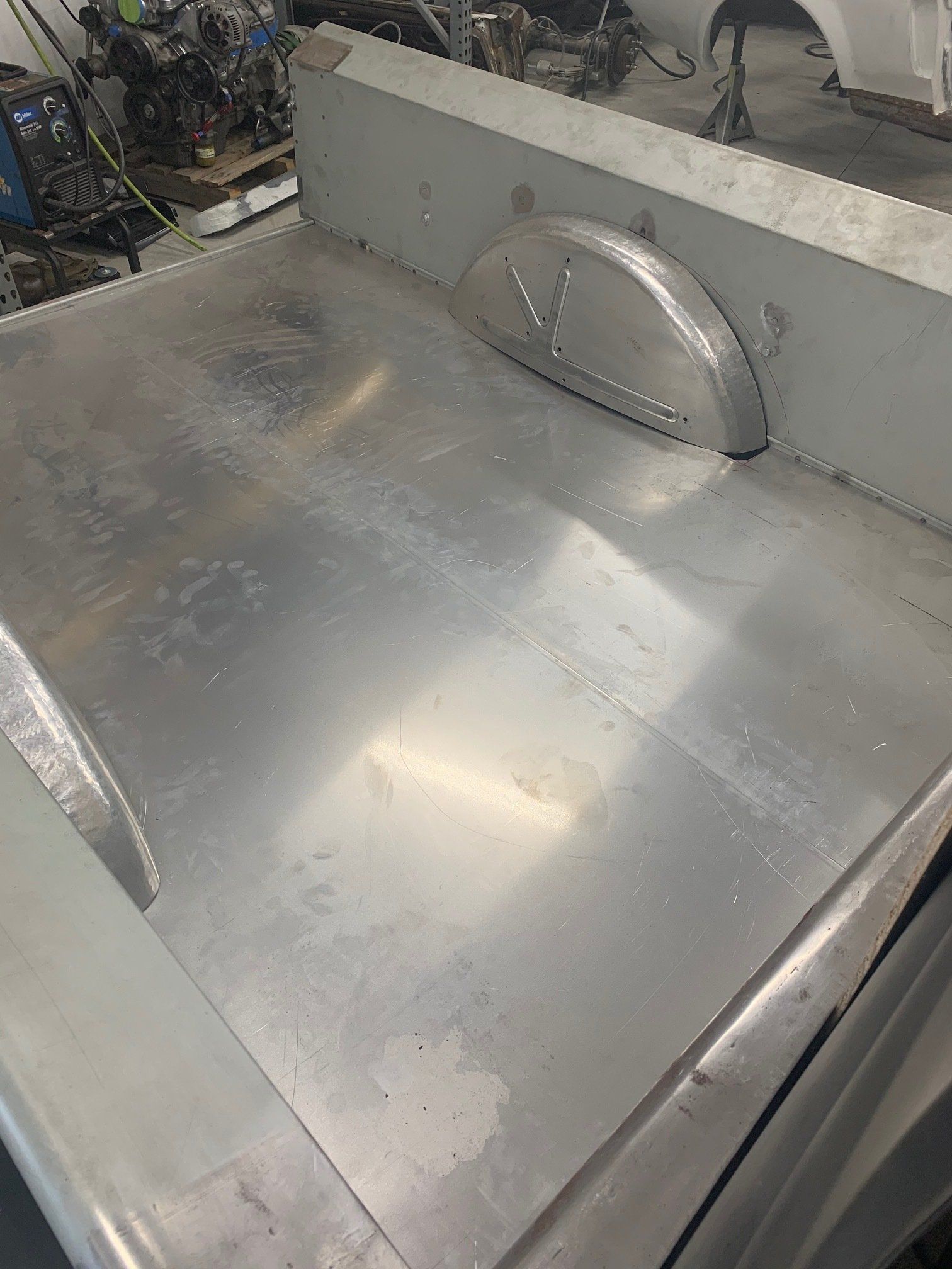 Metallic industrial machine surface with a curved vent on a gray panel.