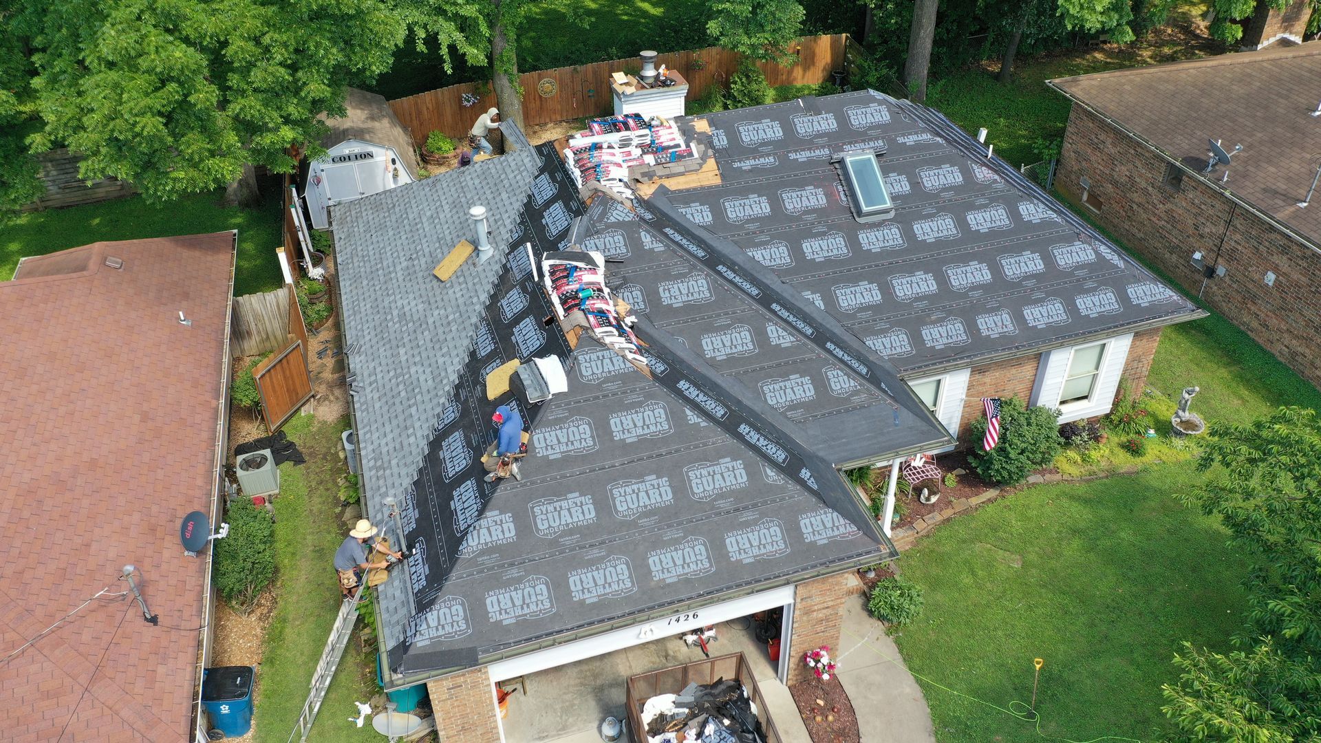 An aerial view of a roof being installed on a house.