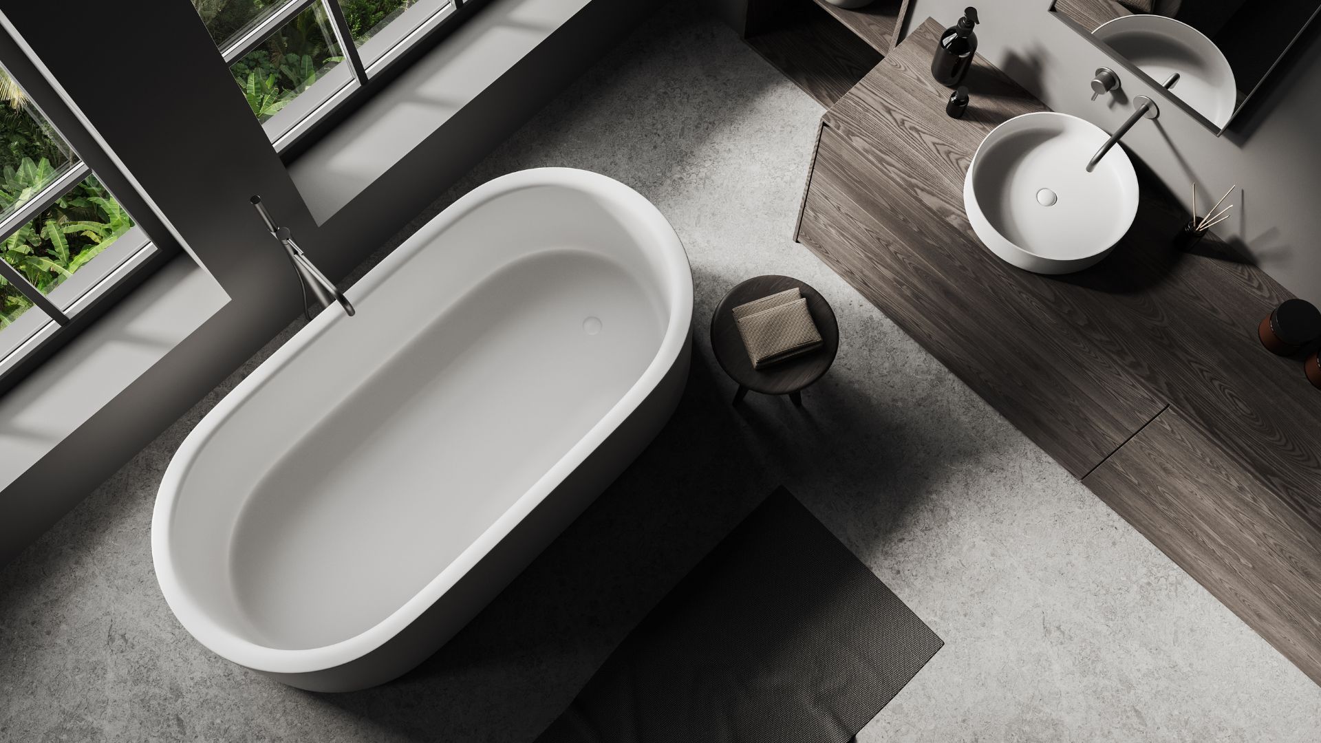 A high-angle view of a modern bathroom with a white oval freestanding bathtub, a vessel sink, and a wooden vanity.