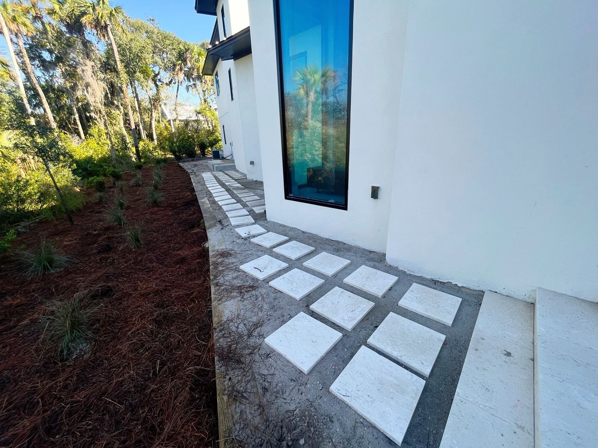 A white house with a walkway in front of it.