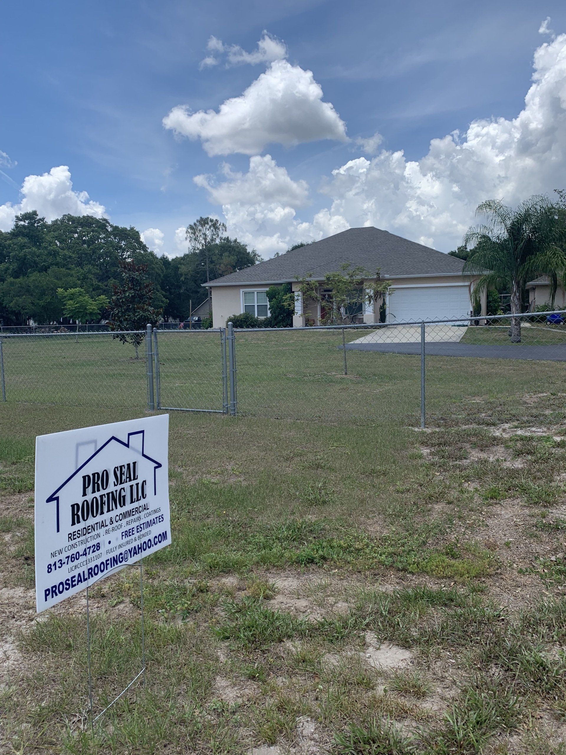 A fenced in yard with a sign that says 