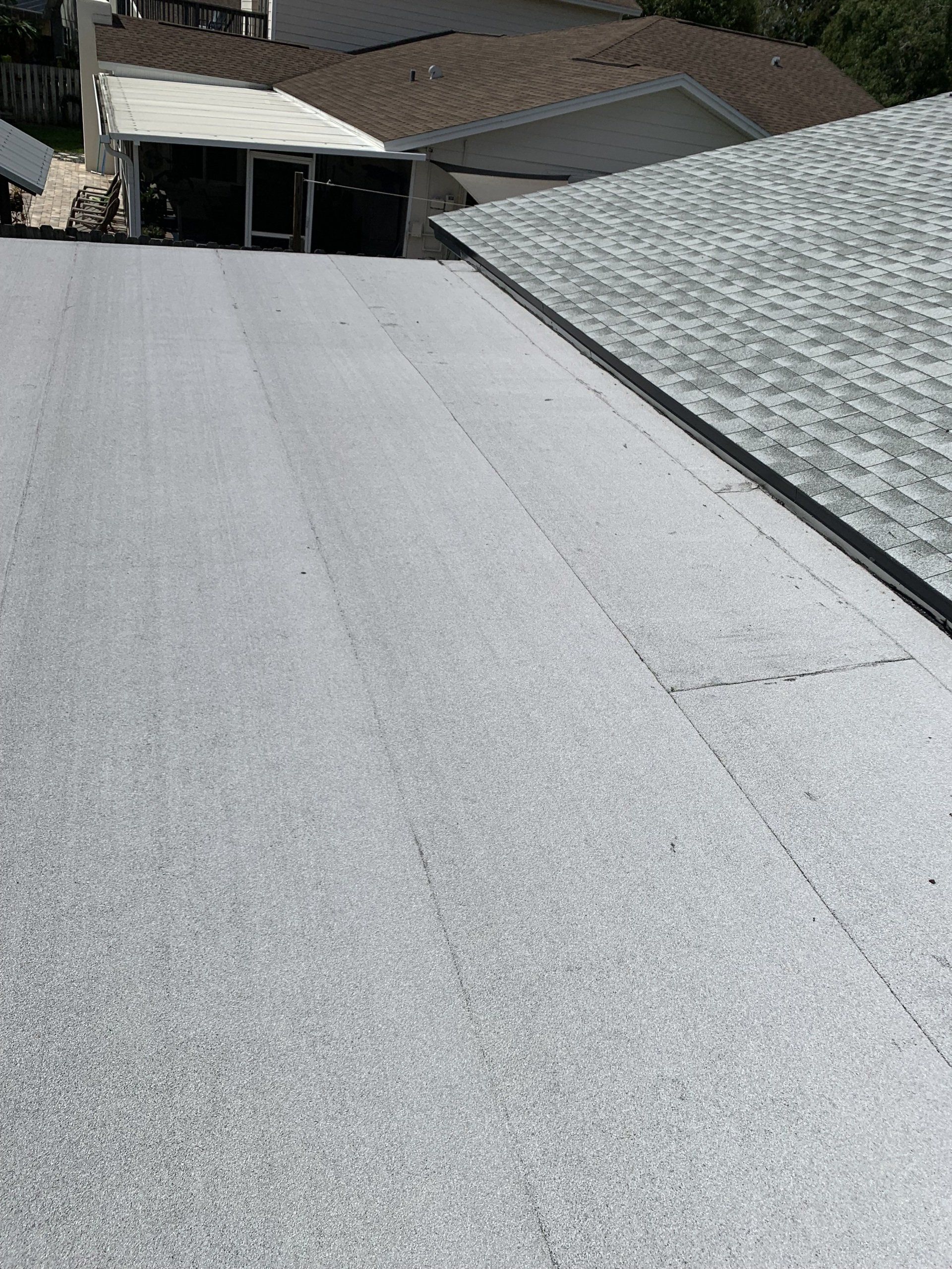 The roof of a house with a gray shingle roof.
