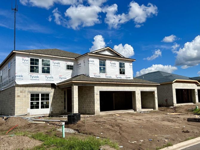 A house that is being built with a blue sky in the background