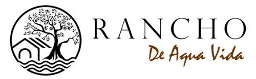 Logo for Rancho De Agua Vida, with a circular illustration of a tree, house, and water, with
