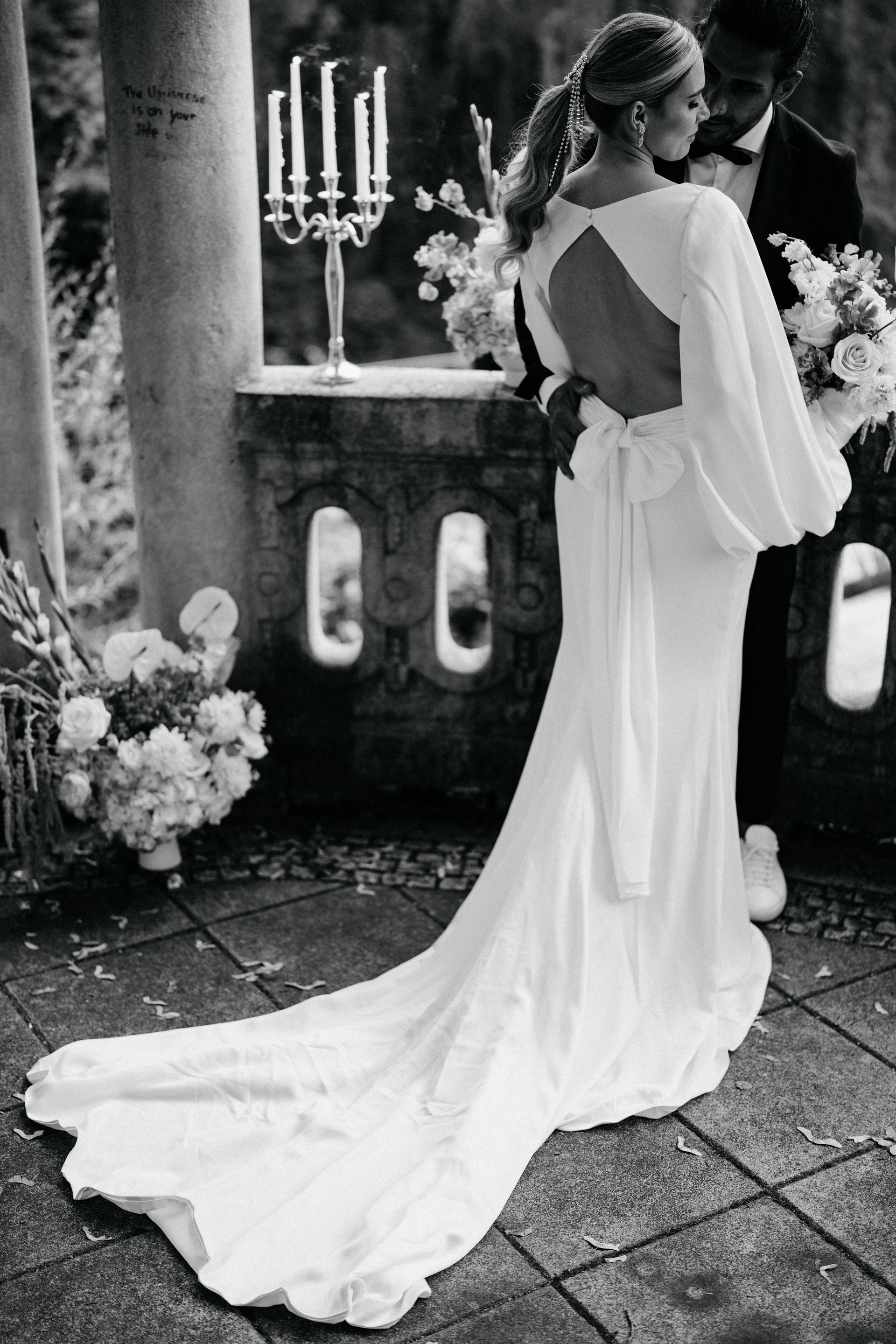 A black and white photo of a bride and groom in a wedding dress.