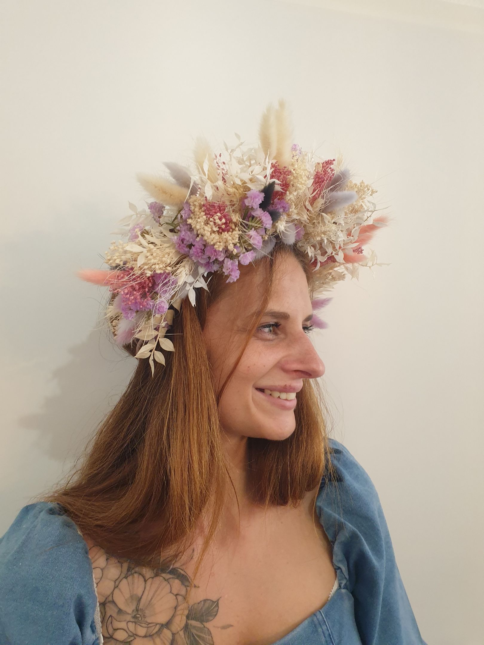 A woman is wearing a flower crown on her head.