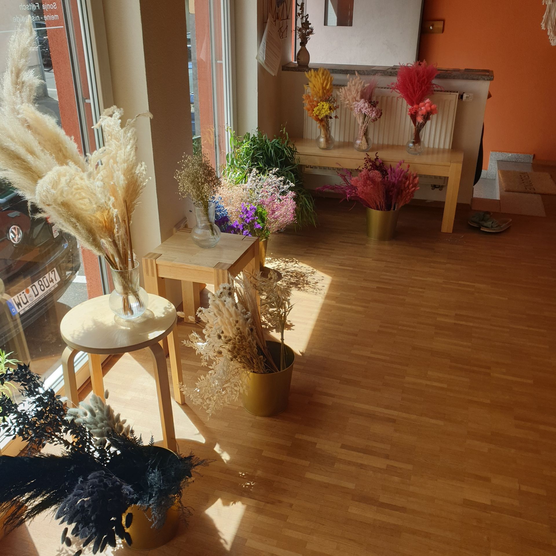 A room with a lot of flowers in vases