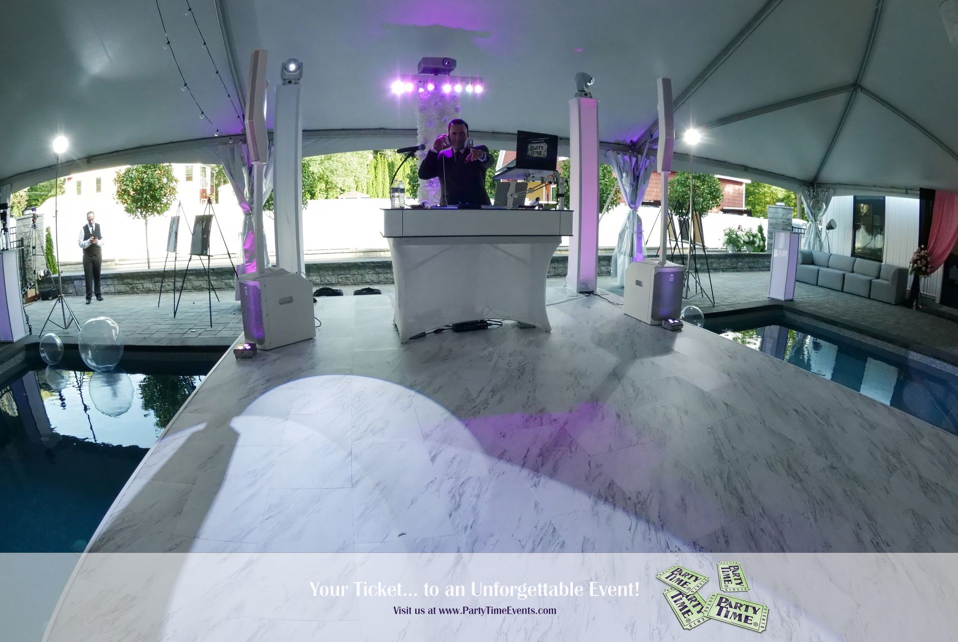 A dj is playing music in a tent next to a pool.