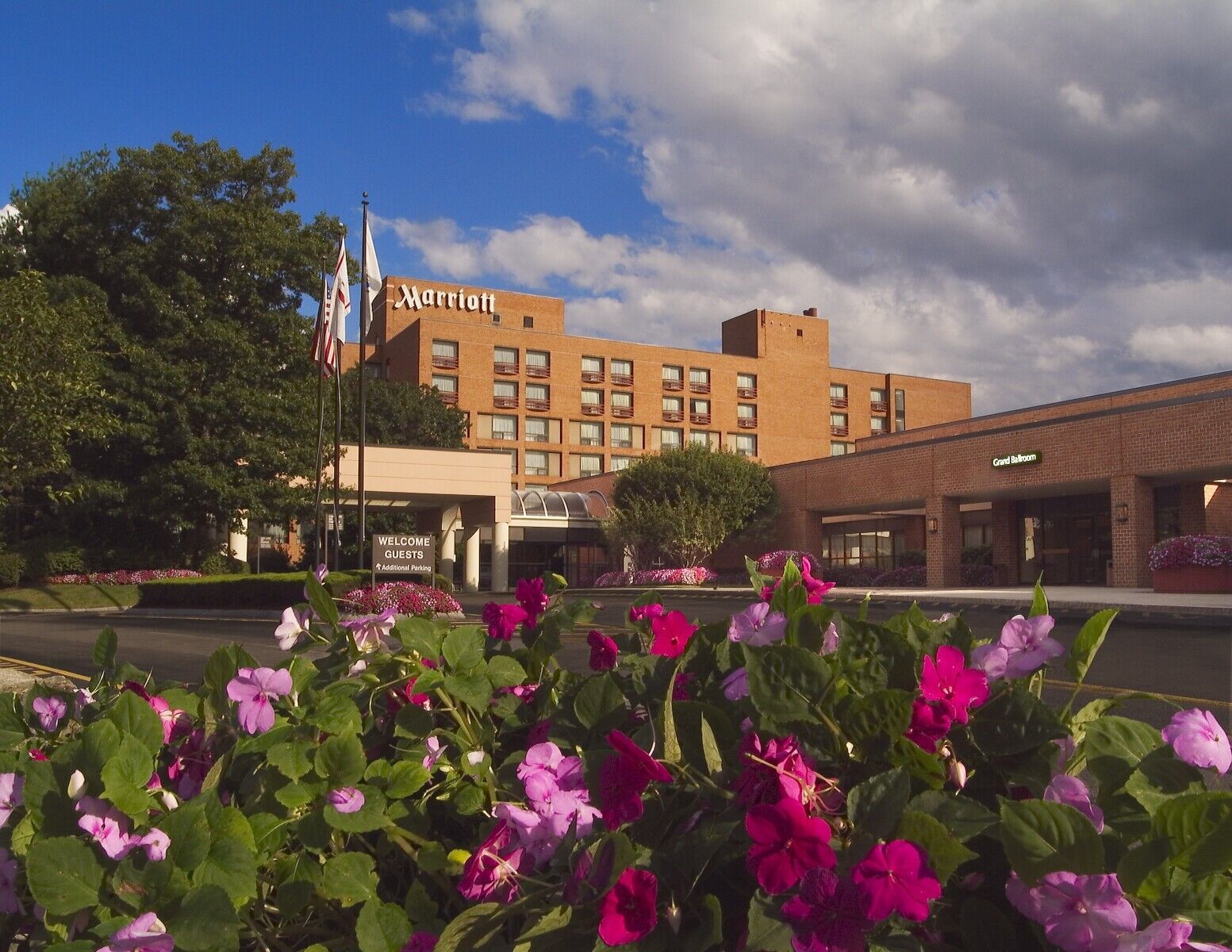 A large brick building with flowers in front of it