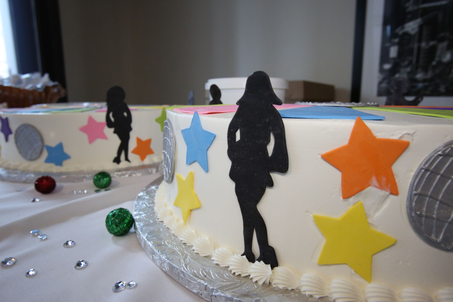 Two cakes with silhouettes of people and stars on them