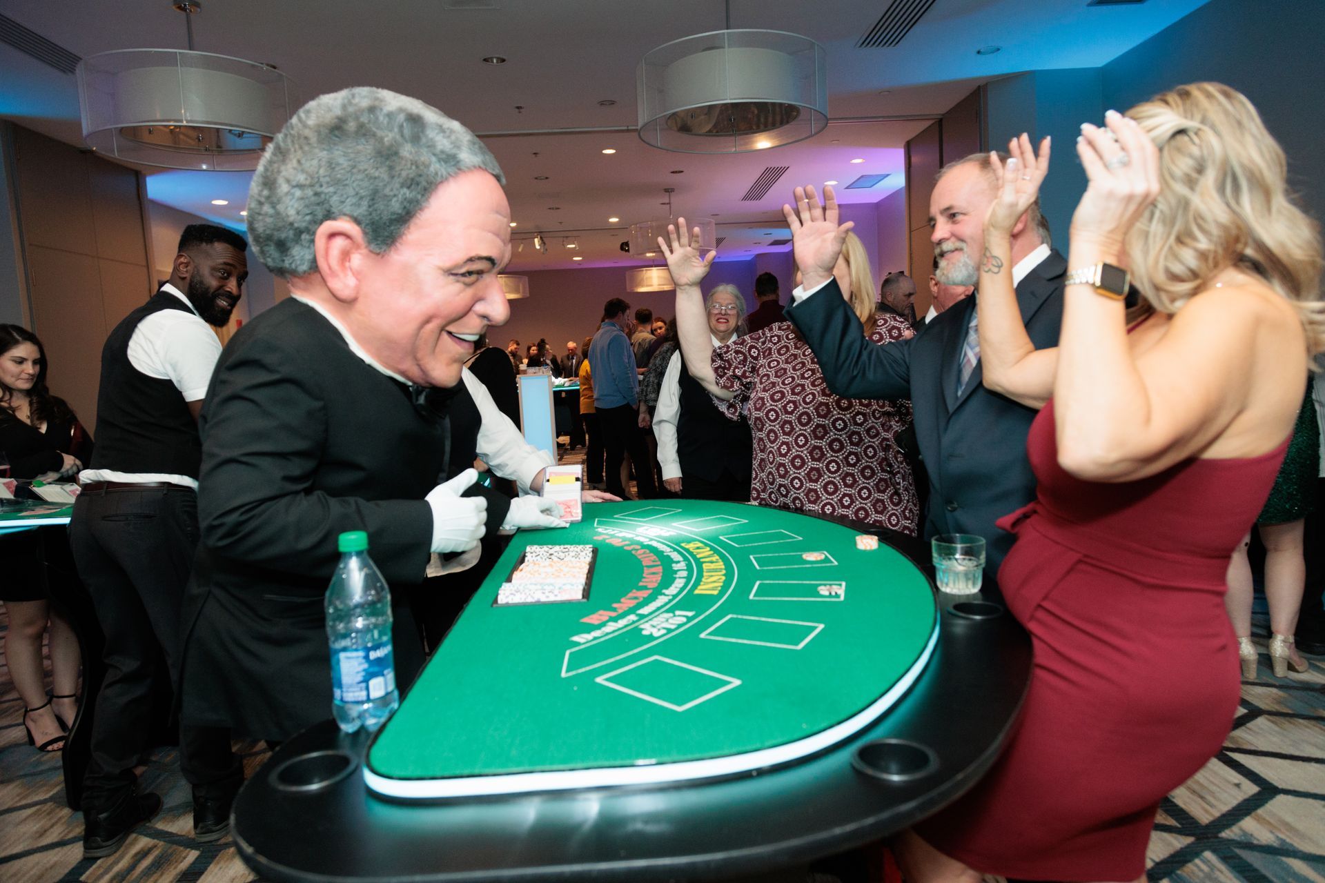 A group of people are playing a game of blackjack at a table.