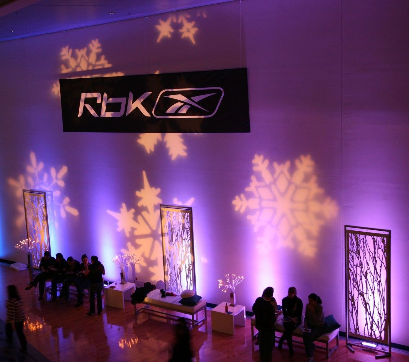 A reebok sign hangs from the ceiling of a room