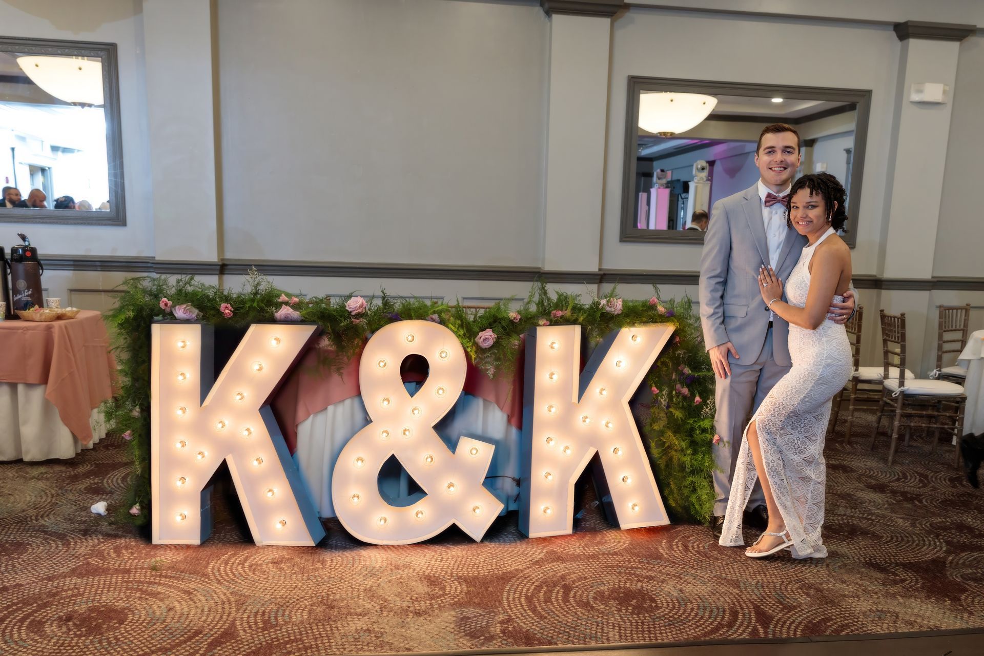 A bride and groom are dancing at their wedding reception