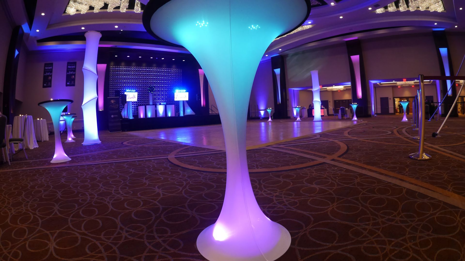 A large room is decorated with purple and blue lights