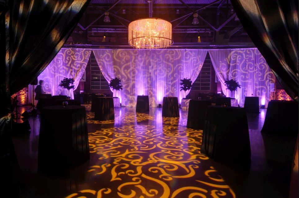 A large room with tables and a chandelier.