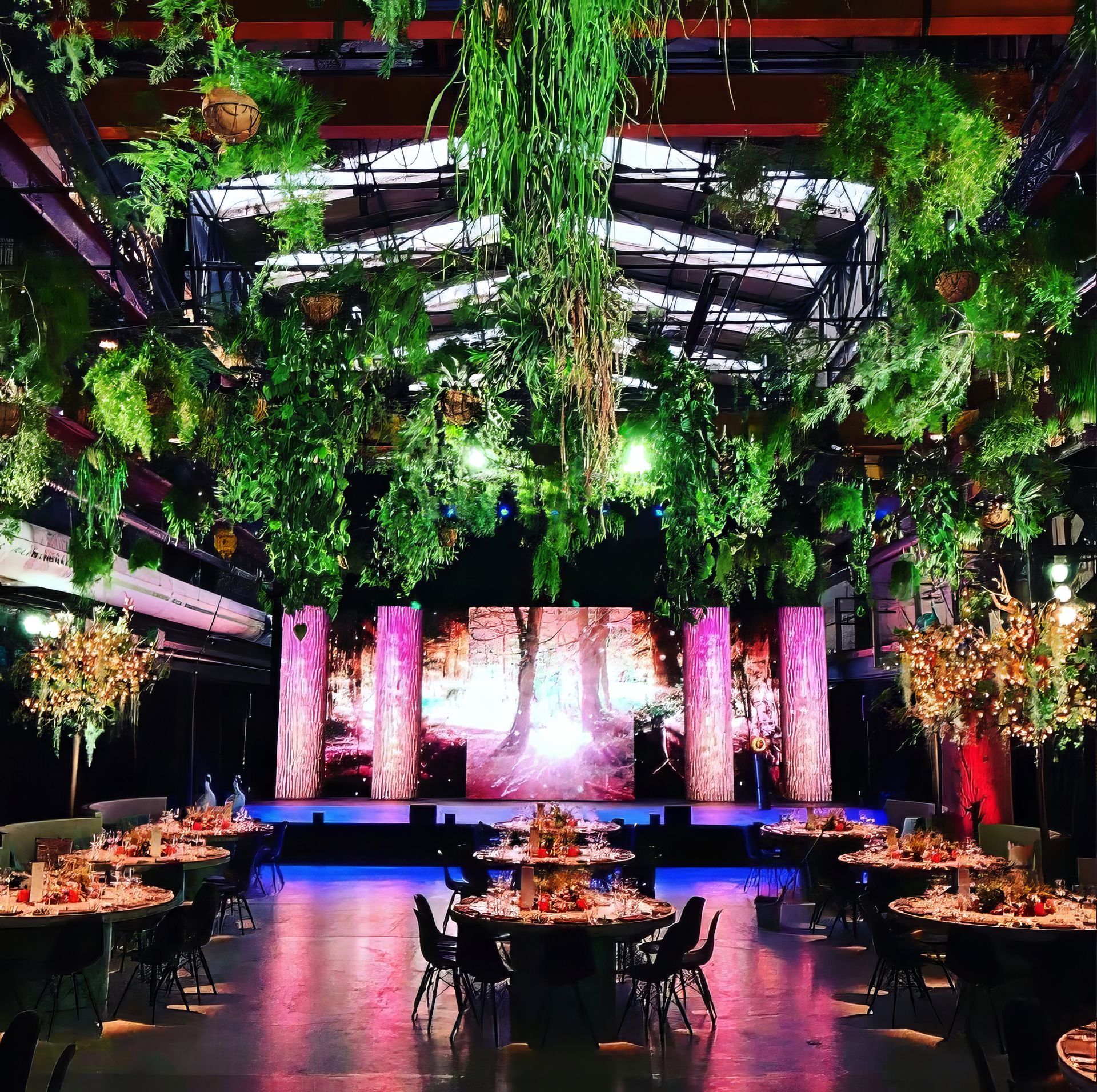 Stage Design by Party Time Events Group featuring LED Video Wall Panels on Stage Set with hanging Greenery