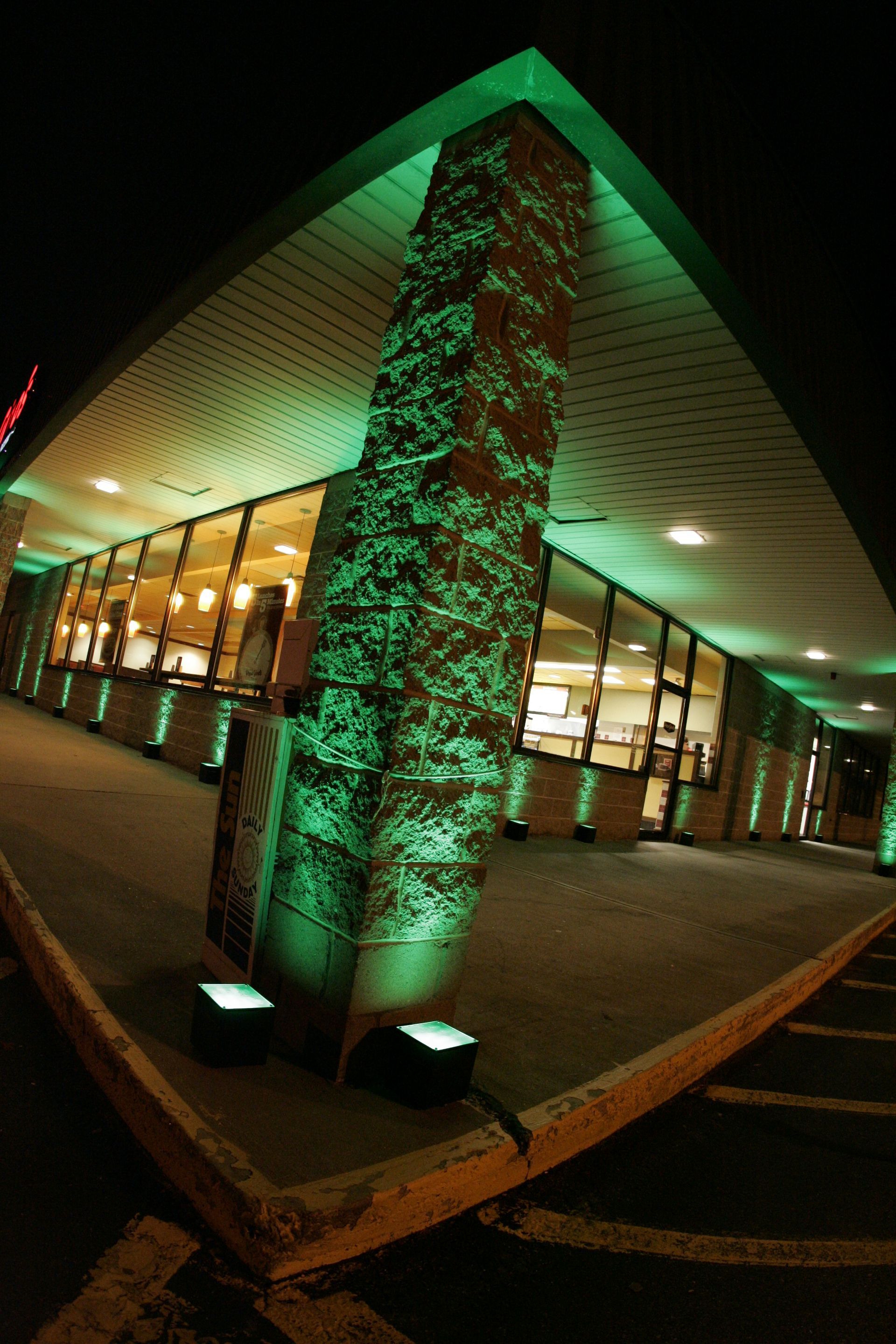 A dj is playing music at a party in a large room.