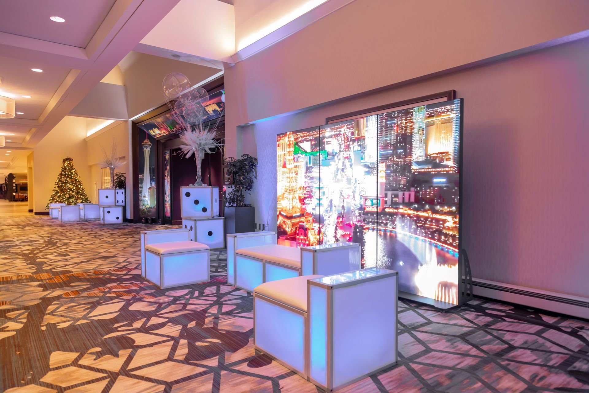 A hallway with chairs and a large screen.
